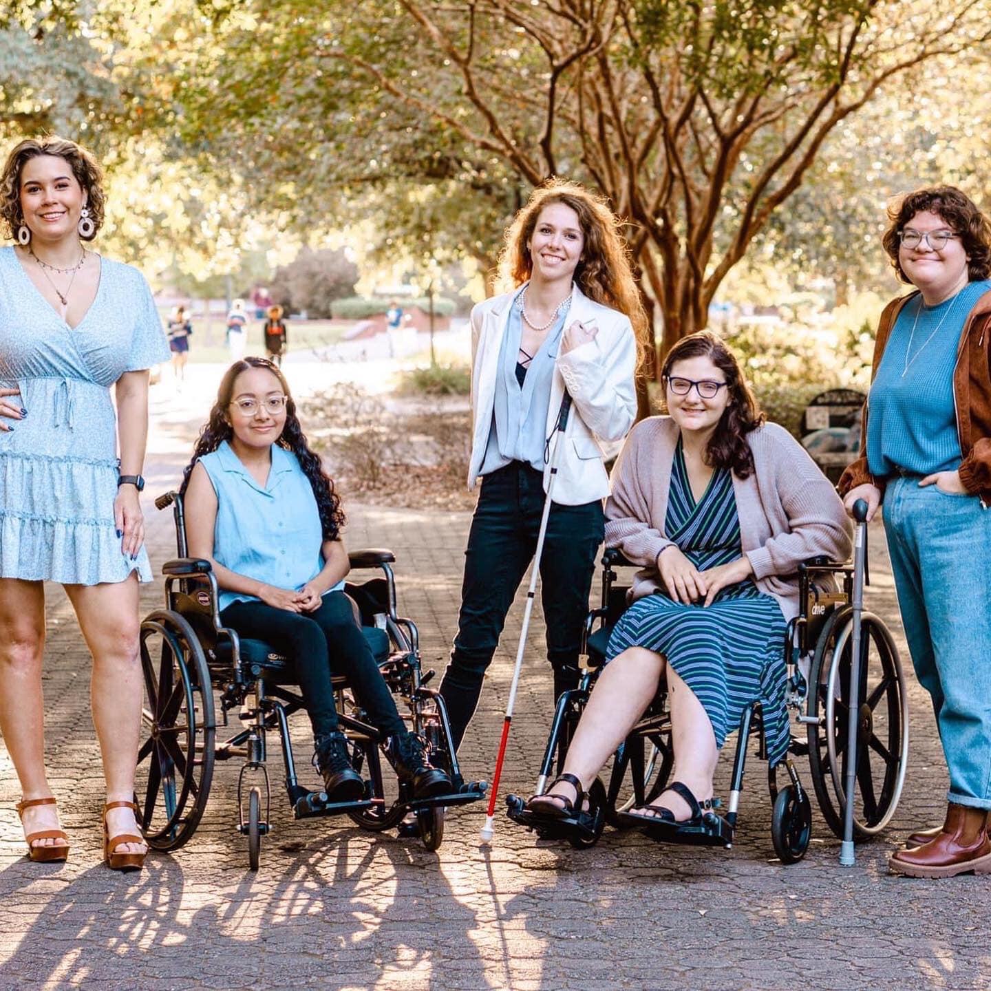 students in the Students with Disabilities Advocacy Group - 2 are seated and 3 are standing