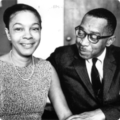 Mamie Phipps Clark smiles at camera while Kenneth Bancroft Clark looks at her